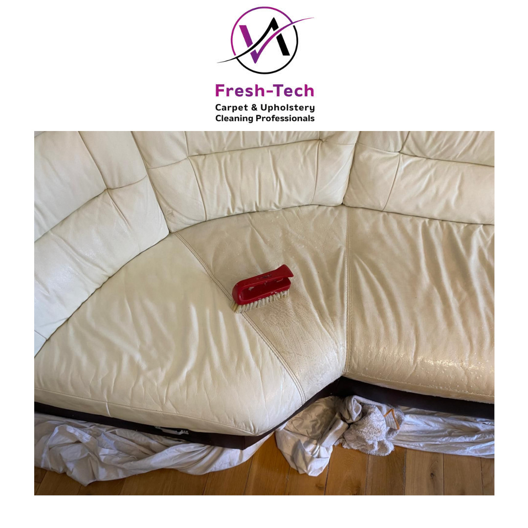 A cream leather sofa showing one seat cleaned, showing a constract with the un cleaned area